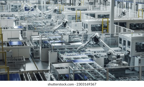 Solar Panels are being Assembled on Conveyor. Large Production Line with White Industrial Robot Arms at Modern Bright Factory. Automated Manufacturing Facility. - Shutterstock ID 2303169367