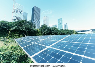solar panels with cityscape of modern city - Shutterstock ID 696895081