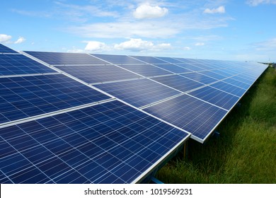 Solar Panels Energy Farm On Sky Background.