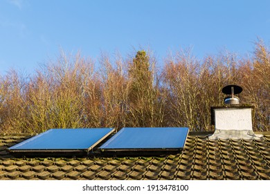 Solar Panels Generating Electricity On A Roof In Low Winter Sunlight, Scotland, United Kingdom