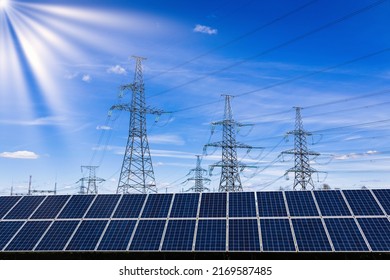 Solar panels, high voltage electricity towers, and sun rays