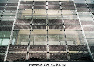 Solar panels installed on the glass walls. The concept of alternative sources of electricity for remote places and inaccessible without centralized electrification. Copy space - Shutterstock ID 1573632433