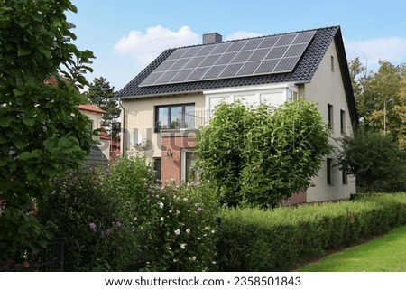 solar panels installed on a private house in Germany, generating electricity using renewable energy from the sun, green energy