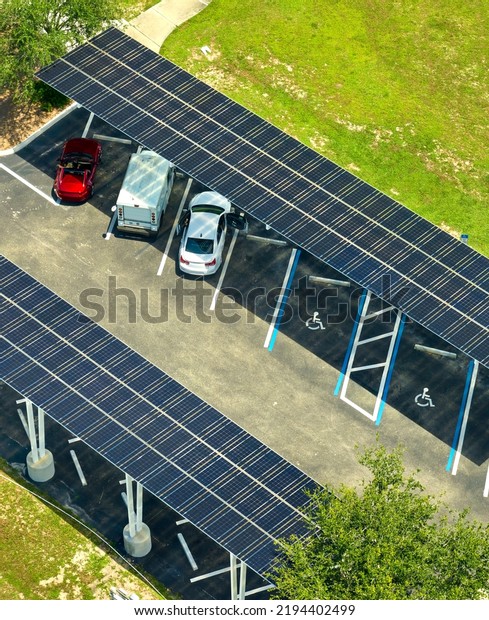 Solar panels installed over\
parking lot for parked cars for effective generation of clean\
energy