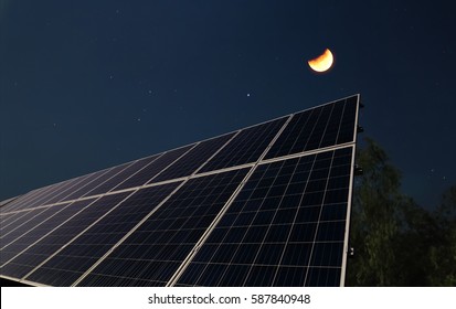 Solar Panels At Night With The Half Moon Before The Sun Rising