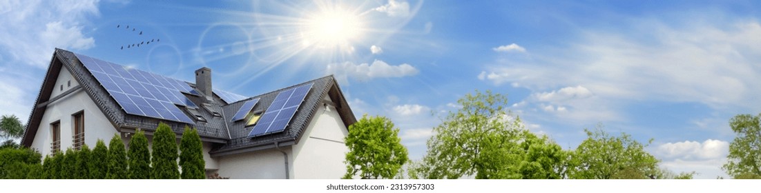 Solar panels on a gable roof. Beautiful, large modern house and solar energy. Rays of the sun. Space for text. - Powered by Shutterstock