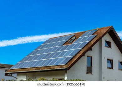 Solar panels on a house roof - Shutterstock ID 1925566178