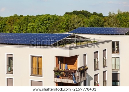 Solar Panels on House Roof. Solar Home. High-rise Buildings with Solar Panels on Roof