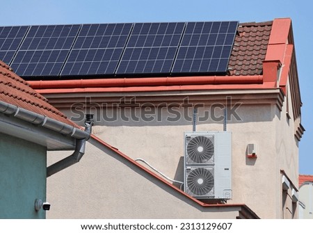 Solar panels on the roof and air conditioner on the wall of a building