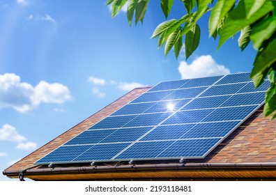Solar panels on the roof. Green energy and money savings concept. - Shutterstock ID 2193118481