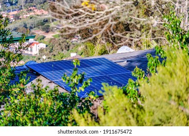 Solar Panels On The Roof Of House In San Diego California Against Green Foliage