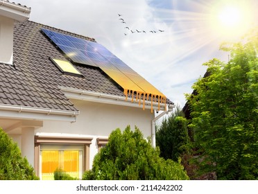 Solar panels on roof of moder house. Concept of saving money. Money saved by using energy from photovoltaics. Conceptual image. - Shutterstock ID 2114242202