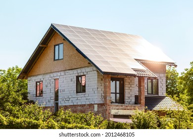 Solar panels on the roof under construction. Construction eco house. Construction of private house of aerated concrete - Shutterstock ID 2012468105
