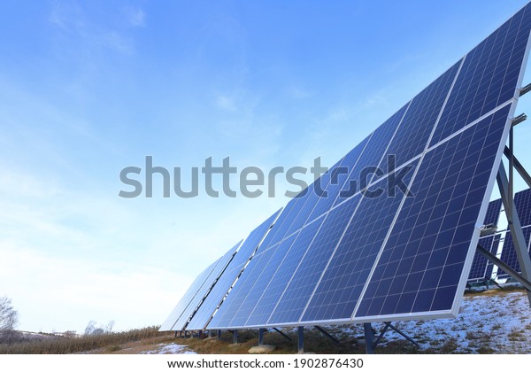Solar panels Photovoltaic cells on a background
of sunrise. Solar panels, the beginning of winter. Alternative
ecological energy.