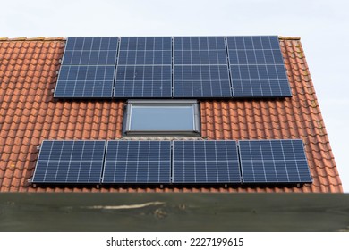 solar panels or photovoltaic power plant on a red tiled roof - Shutterstock ID 2227199615