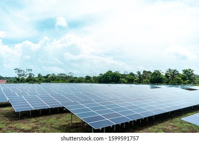 Solar Panels Plant. One In Front Other, Under A Blue Cloudy Sky, In A Rural Island In The Caribbean Of Nicaragua, Central America. 