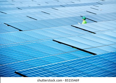 At Solar Panels Power Farm Or Solar Power Plant Of Photovoltaic. Engineer Inspector  Worker Report About Solar Energy From The Station. Sunlight Is Green Industry To Produce Clean Sustainable Energy.