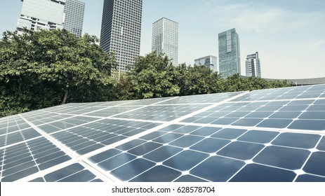 Solar panels and urban construction background - Shutterstock ID 628578704