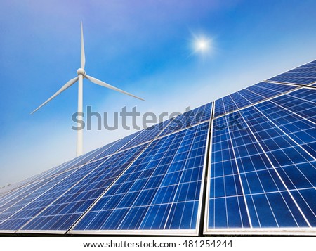 solar panels and wind generators under blue sky on sunset