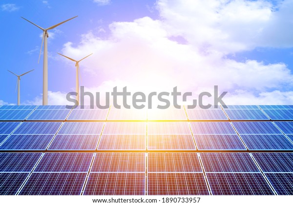 Solar panels and wind power\
generation and aerial photo of new energy solar photovoltaic panels\
outdoors at sunrise. landscape against blue sky with\
clouds.