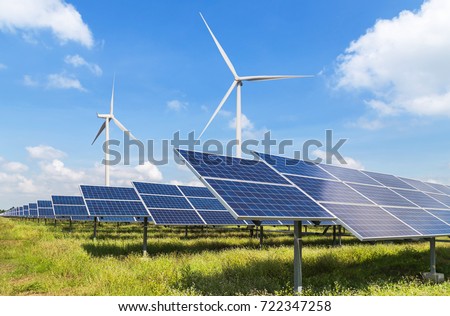 solar panels and wind turbines generating electricity in power station green energy renewable with blue sky background 