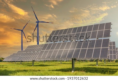 Solar panels wind turbines installed as renewable energy sources for electricity and power supply. Innovation and technology, environmental friendly energy. Solar farm under sunny day