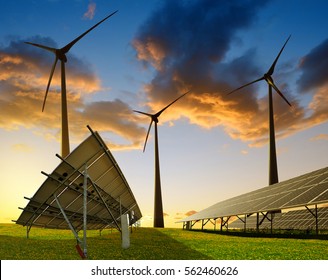 Solar panels with wind turbines at sunset. Power plant using renewable energy.
