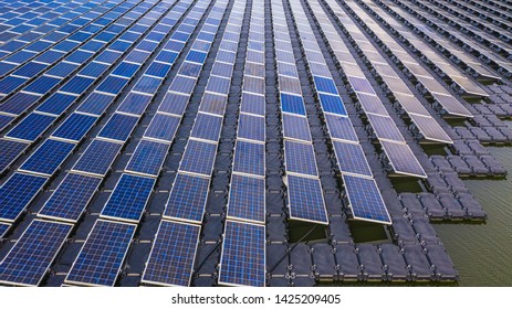 Solar photovoltaic panel in aerial view, rows polycrystalline silicon solar cells or photovoltaic in solar power plant floating on the water in lake, Business alternative renewable power and energy. 