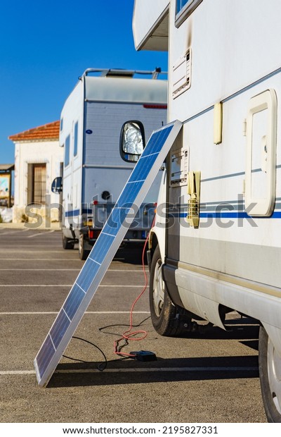 Solar photovoltaic\
panel, charging battery at camper car rv. Electricity in motorhome\
trip. Camping equipment