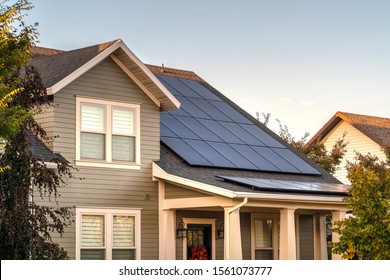 Solar photovoltaic panels on a house roof - Shutterstock ID 1561073777