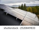 Solar photovoltaic panels on roof on a top of house in forest. Concept of alternative, renewable energy and home autonomy.