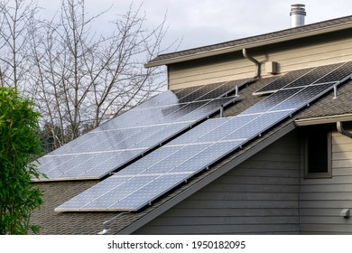 Solar Photovoltaic Panels On A Slanted House Roof In The Pacific Northwest.