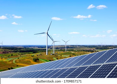 Solar photovoltaic panels and wind turbines. Energy concept - Shutterstock ID 1709857171