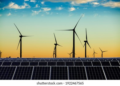 Solar photovoltaic panels and wind turbines. Energy concept - Shutterstock ID 1922467565