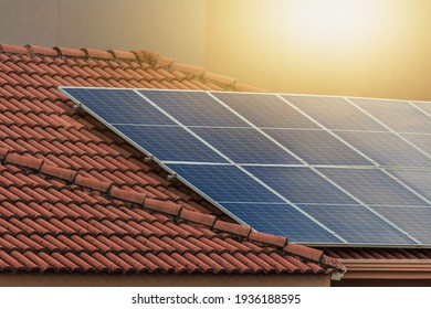 Solar Photovotaic Panel At A Roof At Suset.  Solar Energy House Company Concept Image.