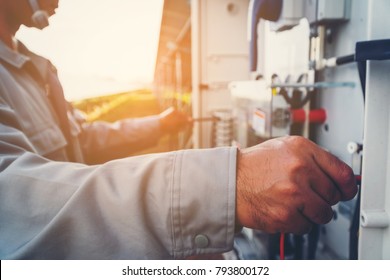 solar power plant to innovation of green energy; engineer or electrician working on checking and maintenance equipment at solar power plant - Shutterstock ID 793800172