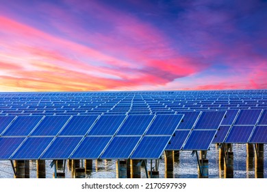 Solar Power Station At Beautiful Sunset. Solar Photovoltaic Power Station On Water. Green Energy Concept.