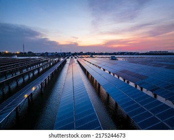 Solar Power Station At Beautiful Sunset. Solar Photovoltaic Power Station On Water. Green Energy Concept.