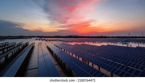 Solar Power Station At Beautiful Sunset. Solar Photovoltaic Power Station On Water. 