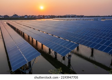 Solar Power Station At Beautiful Sunset. Solar Photovoltaic Power Station On Water. Green Energy Concept.