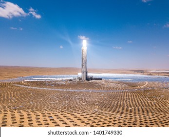 Solar power tower and mirrors that focus the sun's rays upon a collector tower to produce renewable, pollution-free energy, Aerial Image.