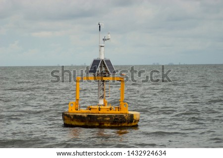 Solar powered buoy in the Gulf of Mexico off the coastline of Orange Beach, Alabama during the summertime measuring oceanographic parameters such as humidity, wind direction and velocity.