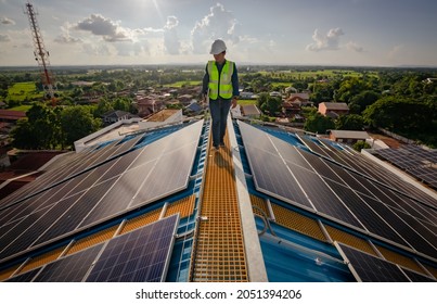 Solar Roofing Engineering Technician Working On Top Of High Building. Solar Company Businessman Is Doing Surveillance Work On Solar Loop.
