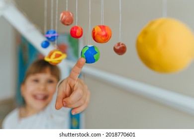 Solar System Model Hanging Over The Kid Bed. DIY Activity For Children Concept. Selective Focus.