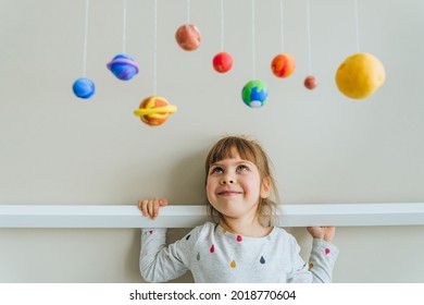 Solar System Model Hanging Over The Kid Bed. DIY Activity For Children Concept.