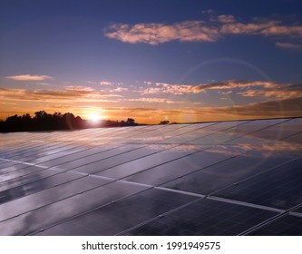 Solarcell Panels Installed On The Rooftop Of Building To Store And Use The Natural Energy Inside The Buildings,blurred Sunset Background, Sustainable Energy And Environmental Friend Concept.
