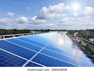 Solarcell rooftop of the house to store and use sun power with electrical appliances inside the house and nearby. Soft and selective focus on panels. - Shutterstock ID 2044618928