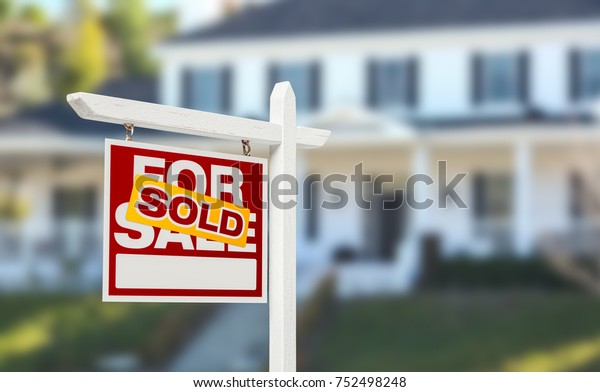 Sold Home For Sale Real Estate Sign in Front of\
Beautiful New House.