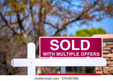 SOLD With Multiple Offers Real Estate Sign Near Purchased House Indicates Red Hot Seller's Market In The Desired Residential Neighborhood. Blurred Outdoor Background.