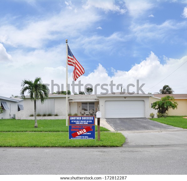 Sold Real
Estate Sign 'Another Success let us help you buy sell your next
home' Suburban Ranch Style Two Car Garage Landscaped Home
residential neighborhood blue sky clouds
USA